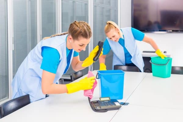 professional cleaners performing office cleaning duties