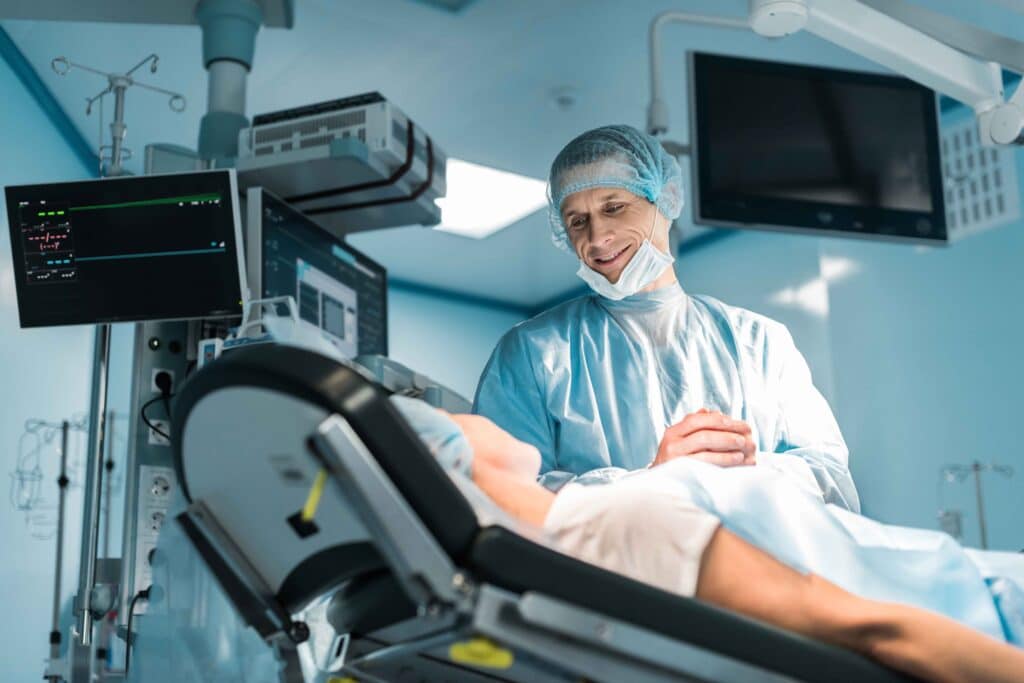 Surgeon smiling and comforting patient in operating room