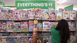 Woman looking at coloring books in a Dollar Tree store